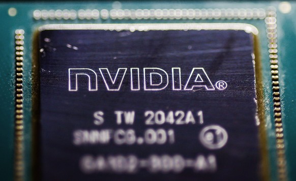 epa12256568 A photo illustration shows a discarded chip by US technology company Nvidia, in Berlin, Germany, 23 July 2025. According to Nvidia, H20 chips will soon be delivered to China again. The hig ...