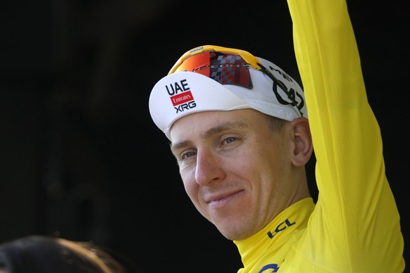 epa13105068 Slovenian cyclist Tadej Pogacar of UAE Team Emirates XRG celebrates on the podium wearing the overall leader's yellow jersey after Stage 8 of the Tour de France, a 180.4 km route from ...