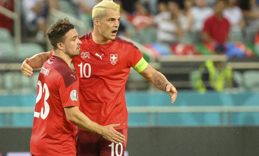 epa09288931 Switzerland&#039;s midfielder Xherdan Shaqiri (L) celebrates the second goal with Switzerland&#039;s midfielder Granit Xhaka during the UEFA EURO 2020 group A preliminary round soccer matc ...