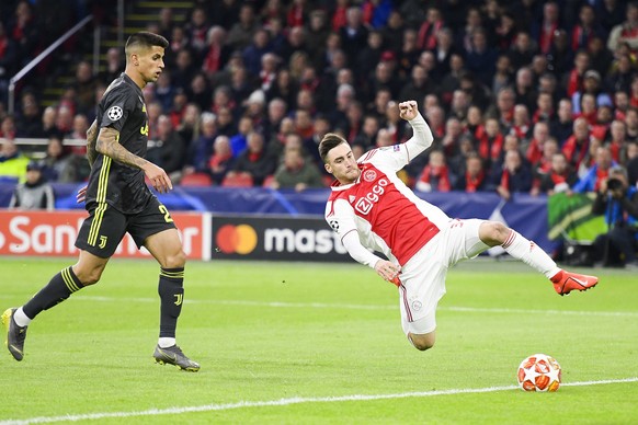 epa07497462 Nico Tagliafico (R) of Ajax and Joao Cancelo (L) of Juventus in action during the UEFA Champions League quarter final first leg soccer match betweeen Ajax Amsterdam and Juventus FC in Amst ...