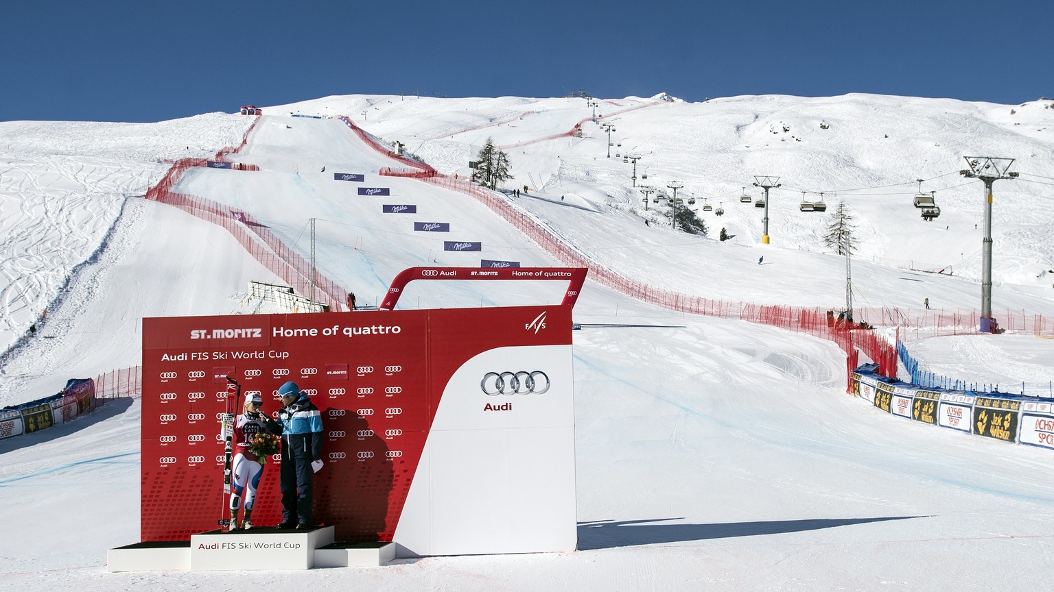 Lara Gut of Switzerland, left, winner, speaks with a journalist during the winner ceremony after the women&#039;s downhill race of the FIS Alpine Ski World Cup Season in St. Moritz, Switzerland, on Sa ...