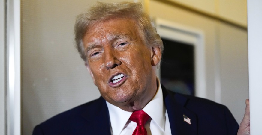 President Donald Trump speaks to reporters aboard Air Force One while en route to Joint Base Andrews, Md. after attending a memorial for conservative activist Charlie Kirk in Glendale, Ariz., Sunday,  ...