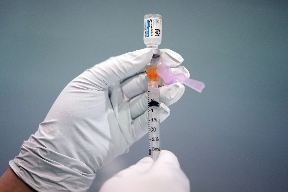 FILE - In this March 26, 2021, file photo a member of the Philadelphia Fire Department prepares a dose of the Johnson &amp; Johnson COVID-19 vaccine at a vaccination site setup in Philadelphia. Acting ...