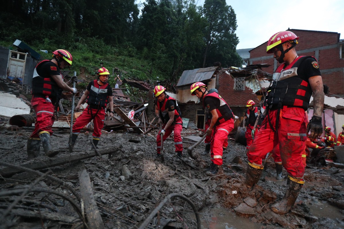 epa07766440 Rescuers work on the landslide triggered by Typhoon Lekima in Yongjia county in east China's Zhejiang province in China, 10 August 2019. According to news reports, at least 22 people  ...