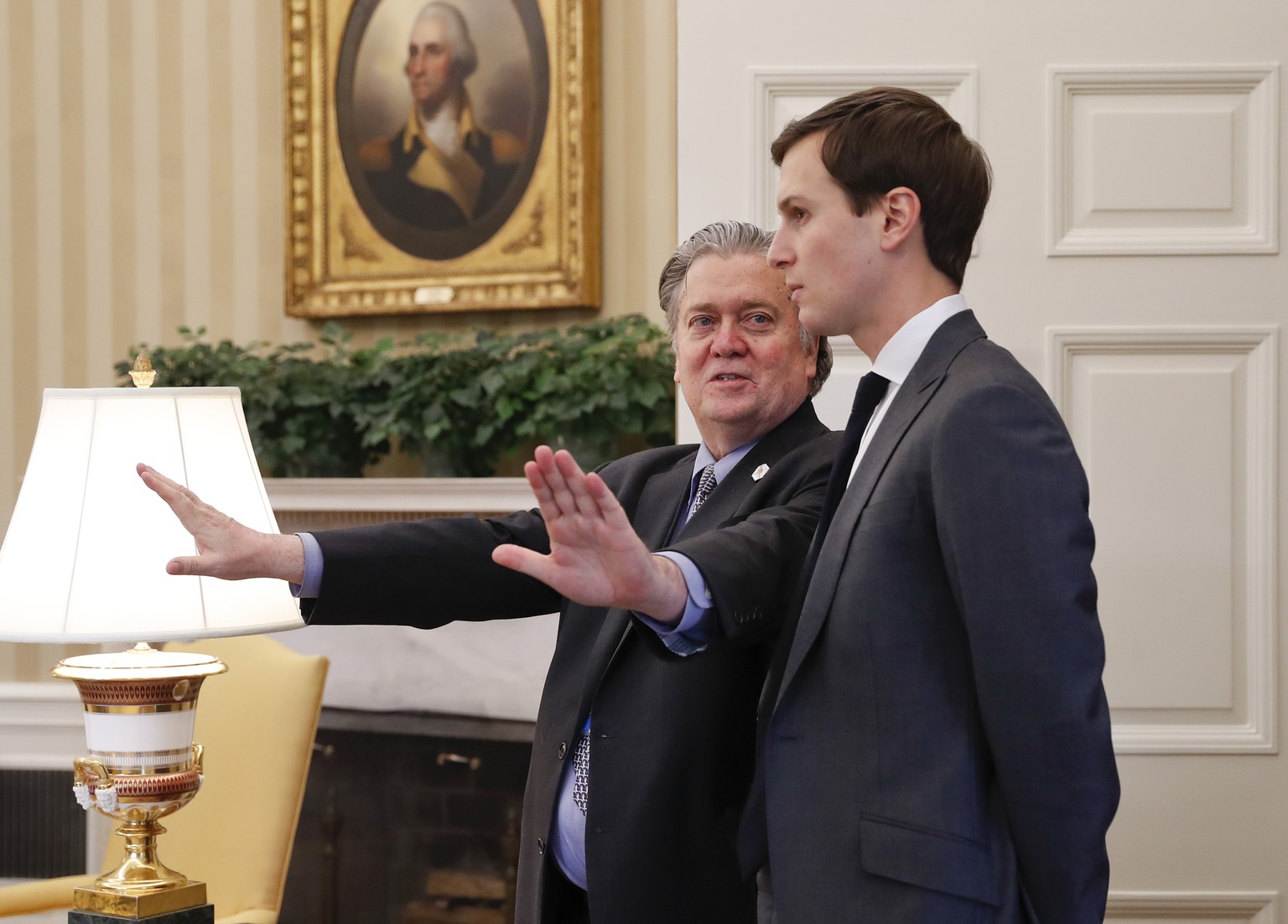 Counselor to the President Steve Bannon, left, talks with White House senior advisers Jared Kushner in the Oval Office of the White House in Washington, Friday, Feb. 3, 2017. (AP Photo/Pablo Martinez  ...