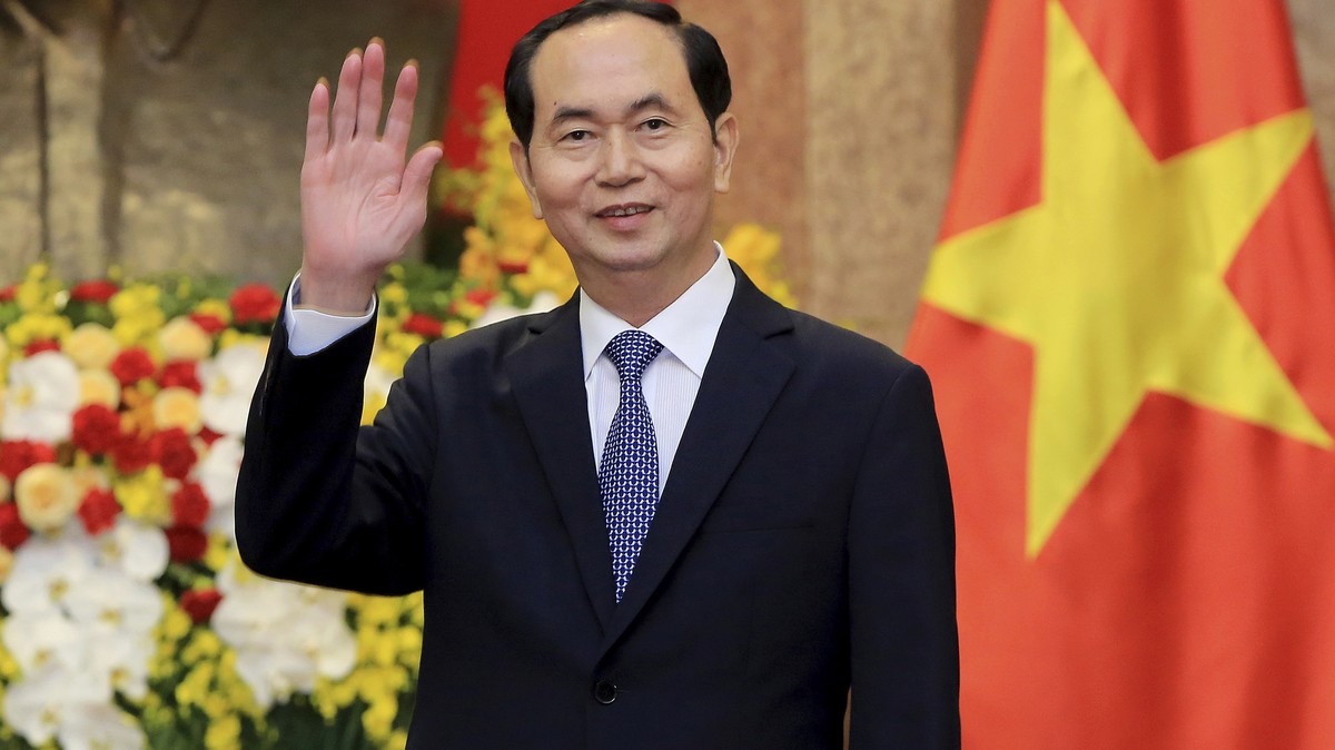 FILE - In this March 23, 2018, file photo, Vietnamese President Tran Dai Quang greets journalists as he waits for arrival of Russian Foreign Minister Sergei Lavrov at the Presidential Palace in Hanoi, ...