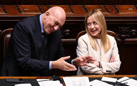 epa12812343 Italian Premier Giorgia Meloni (R) with Italian minister of Defense, Guido Crosetto (L), as she reports to the Lower House on Middle East crisis ahead of European Council, in Rome, Italy,  ...