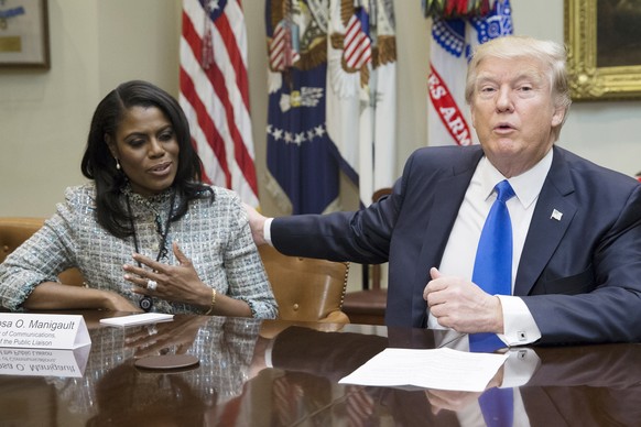epa06940921 (FILE) - US President Donald J. Trump (R) speaks beside then Director of Communications for the Office of Public Liaison Omarosa Manigault-Newman (L) during a meeting on African American H ...