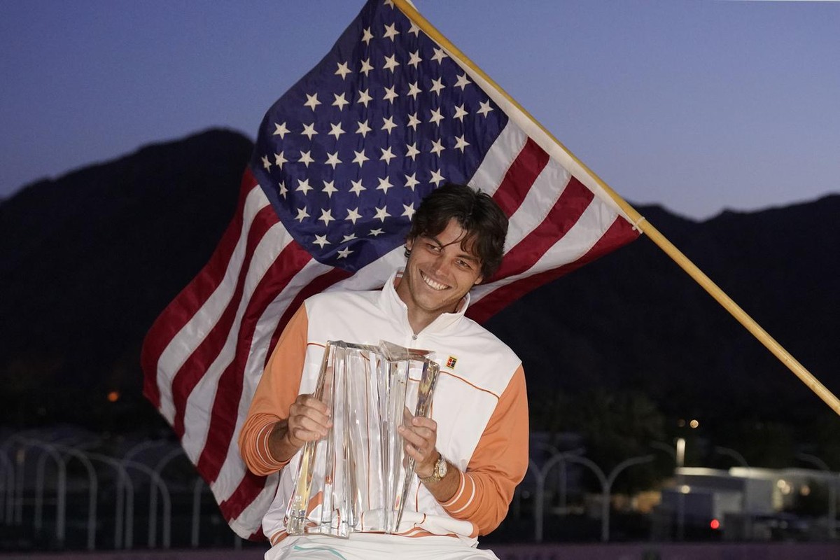 Taylor Fritz poses for photos after winning the men's singles final over Rafael Nadal in the BNP Paribas Open tennis tournament Sunday, March 20, 2022, in Indian Wells, Calif. (AP Photo/Mark J. T ...