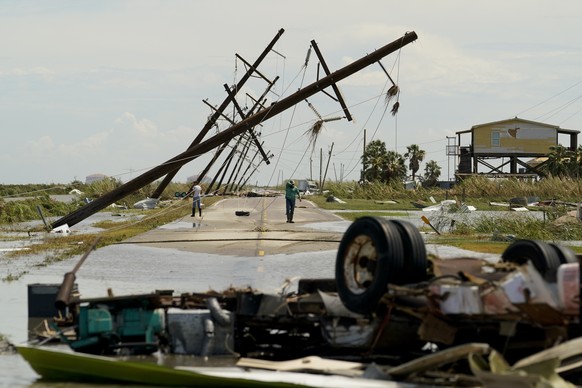 People survey the damage left in the wake of Hurricane Laura Thursday, Aug. 27, 2020, in Holly Beach, La. (AP Photo/Eric Gay)