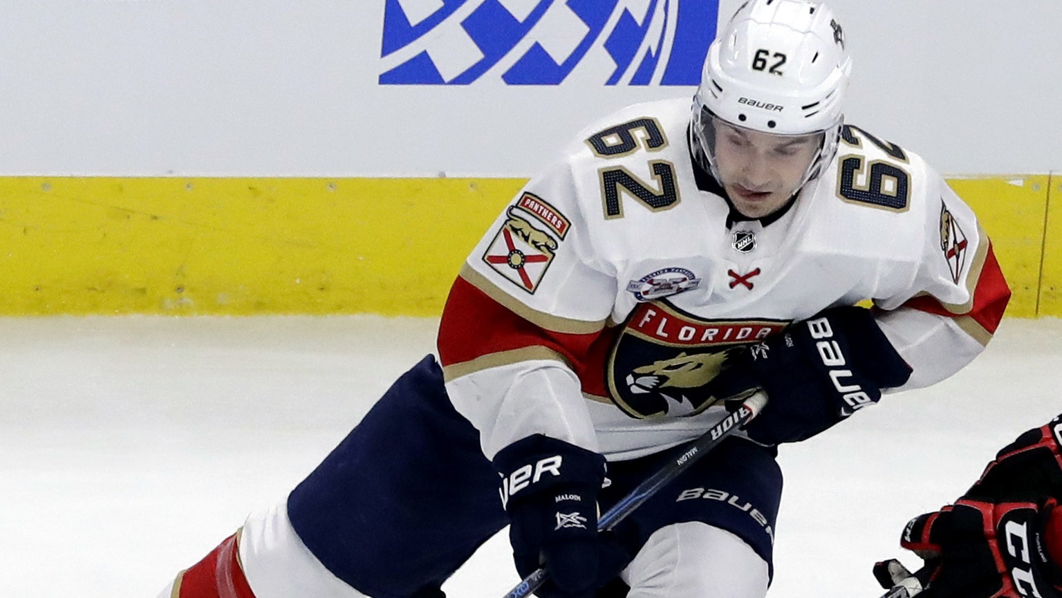 Chicago Blackhawks defenseman Gustav Forsling, right, battles for the puck against Florida Panthers center Denis Malgin during the third period of an NHL hockey game Sunday, Dec. 23, 2018, in Chicago. ...