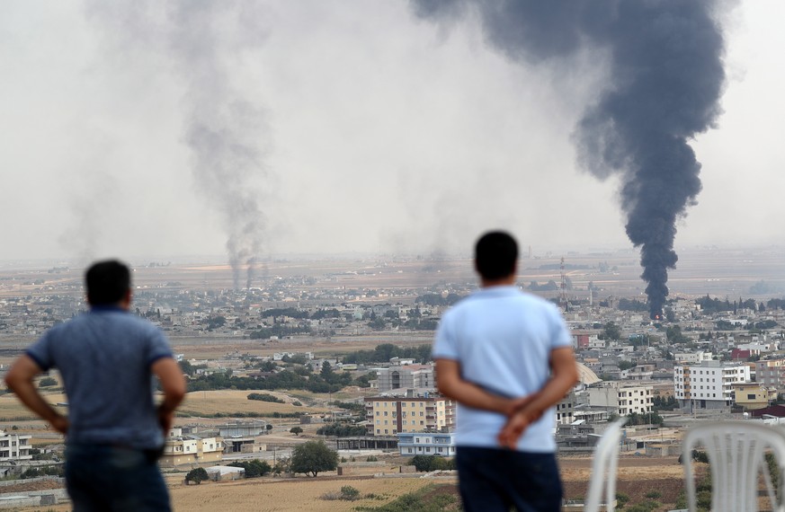 epa07925332 A picture taken from Turkish territory shows smoke rising from targets inside Syria during bombardment by Turkish forces at Ras al-Ein town, as seen from Ceylanpinar, in Sanliurfa, Turkey, ...