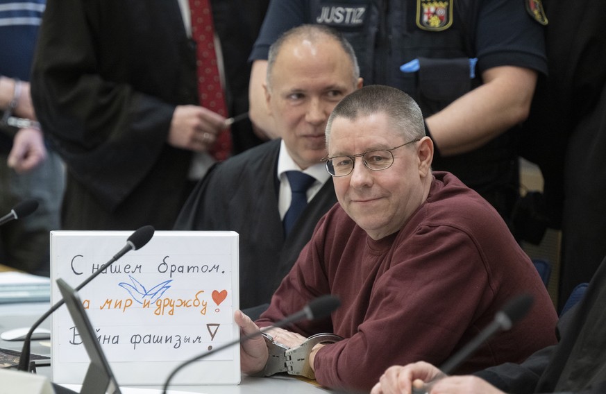 At the start of the trial the defendant Sven Birkmann sits in handcuffs on the dock in the courtroom in Koblenz, Germany, Wednesday, May 17, 2023. Five people are going on trial in Germany accused of ...