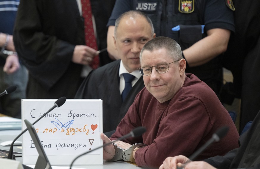 At the start of the trial the defendant Sven Birkmann sits in handcuffs on the dock in the courtroom in Koblenz, Germany, Wednesday, May 17, 2023. Five people are going on trial in Germany accused of  ...