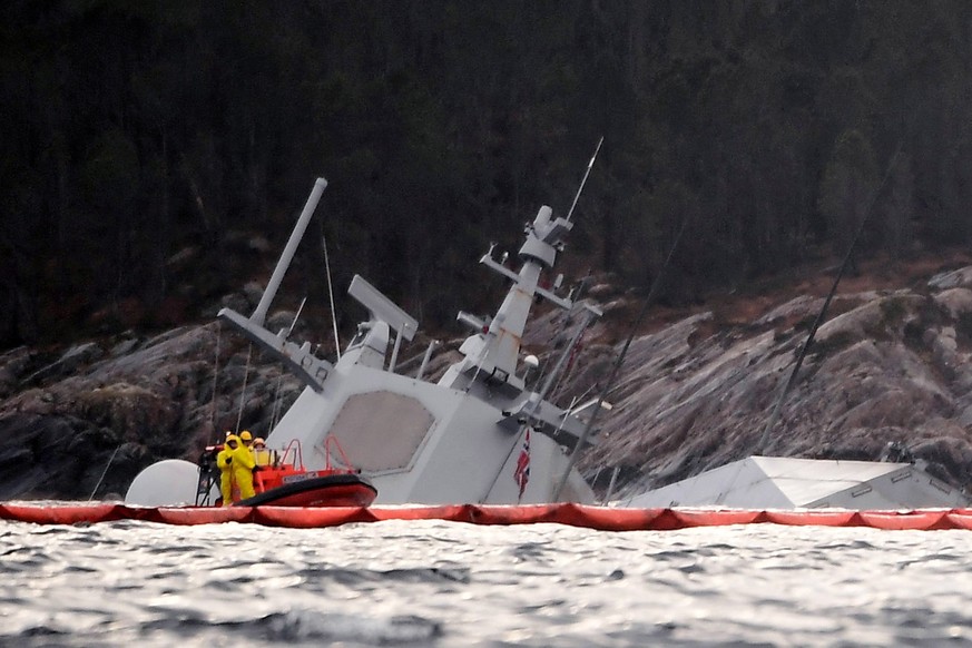 epa07162237 A view of the Norwegian frigate KNM Helge Ingstad partly under water in the sea near Bergen, western Norway, 13 November 2018. The frigate capsized after colliding with the tank ship Sola  ...