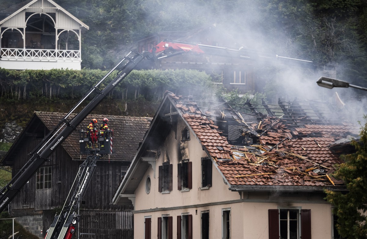 epa13182440 Firefighters try to put out a fire at a building with a restaurant and apartments in Thusis in eastern Switzerland, 21 August 2026. Five people are reported missing following a major fire, ...