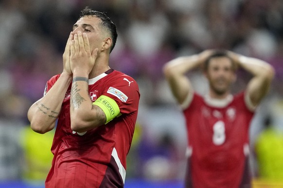 Switzerland&#039;s Granit Xhaka holds his face after missing a chance to score during a Group A match between Switzerland and Germany at the Euro 2024 soccer tournament in Frankfurt, Germany, Sunday,  ...