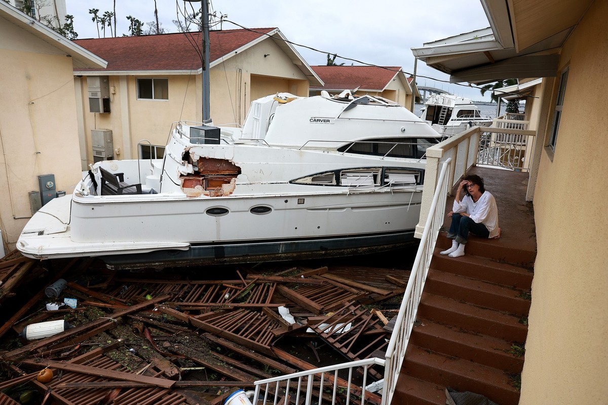 FORT MYERS FLORIDA - SEPTEMBER 29: Brenda Brennan sits next to a boat that pushed against her apartment when Hurricane Ian passed through the area on September 29, 2022 in Fort Myers, Florida. Mrs. Br ...
