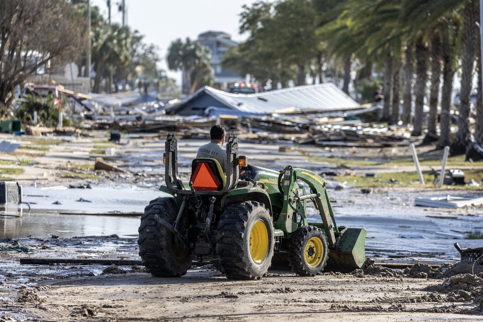 epa11628681 A worker removes the debris left behind by Hurricane Helene in Cedar Key, Florida, USA, 27 September 2024. The storm hit the Gulf Coast of Florida as a Category 4 hurricane overnight, leav ...