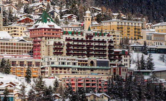 Exterior view of the hotel Badrutt's Palace, center, in St. Moritz, Switzerland, Monday, Jan. 18, 2021. Swiss authorities say they have placed two hotels under quarantine and ordered all guests and employees be tested after a new variant of the coronavirus was detected among them in the upscale skiing resort of St. Moritz. (Giancarlo Cattaneo/Keystone via AP)