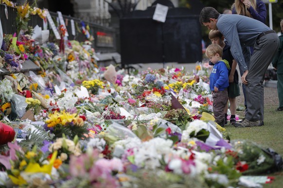 In this Monday, March 18, 2019, file photo, mourners lay flowers on a wall at the Botanical Gardens in Christchurch, New Zealand. A steady stream of mourners paid tribute at makeshift memorial to the  ...