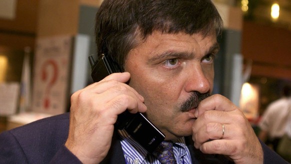 President of the International Ice Hockey Federation (IIHF) and IOC member swiss Rene Fasel talks on his mobile phone at the International Olympic Comittee (IOC) session, in Seoul, South Korea, Friday ...