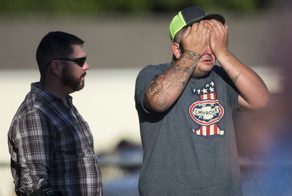 A man wipes his eyes after a deadly shooting at the First Baptist Church in Sutherland Springs, Texas, Sunday, Nov. 5, 2017. A man opened fire inside of the church in the small South Texas community o ...