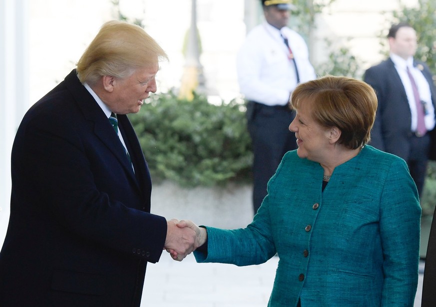 epa05854386 US President Donald J. Trump (L) welcomes German Chancellor Angela Merkel at the White House in Washington, DC, USA, 17 March 2017. Merkel&#039;s original visit on 14 March had to be postp ...