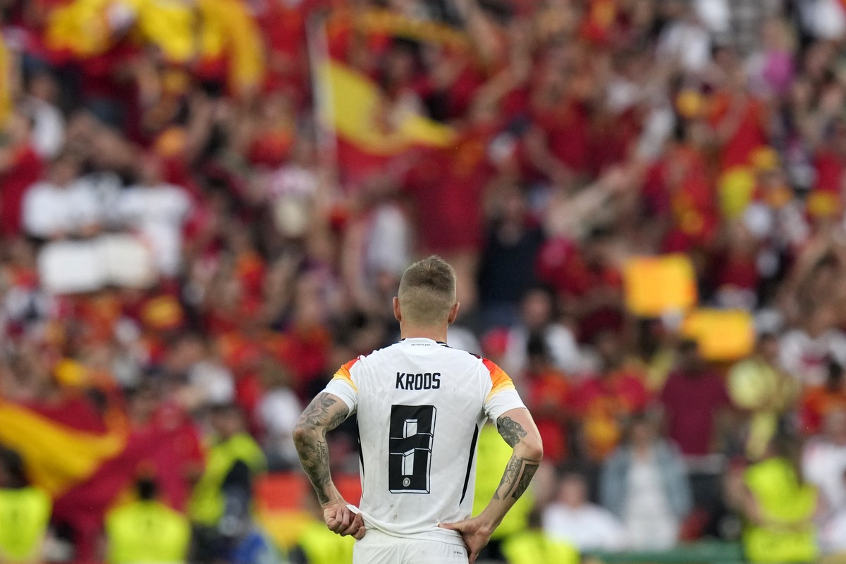 Germany's Toni Kroos watches fans celebrate at the end of a quarter final match between Germany and Spain at the Euro 2024 soccer tournament in Stuttgart, Germany, Friday, July 5, 2024. (AP Photo ...