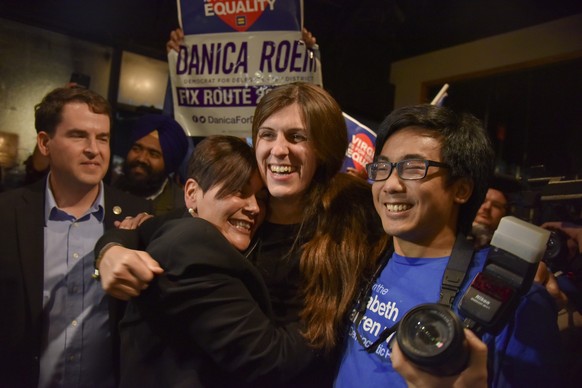 Danica Roem, center, who ran for house of delegates against GOP incumbent Robert Marshall, is greeted by supporters as she prepares to give her victory speech with Prince William County Democratic Com ...