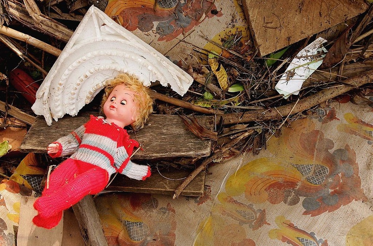 KALUTURA, SRI LANKA - DECEMBER 30: A toy doll lies amongst the wreckage after a massive tsunami wave swept across coastal Sri Lanka on December 30, 2004 in Kalutura, Sri Lanka. Tens of thousands were  ...