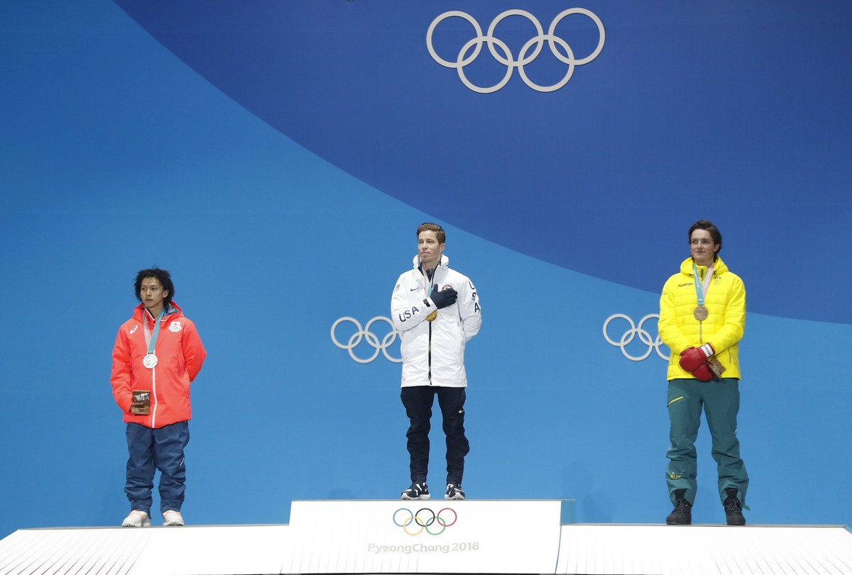 epa06524107 Gold medalist Shaun White of the USA (C), silver medalist Hirano Ayumu (L) of Japan and bronze medal winner Scotty James of Australia during the medal ceremony for the men's Snowboard ...
