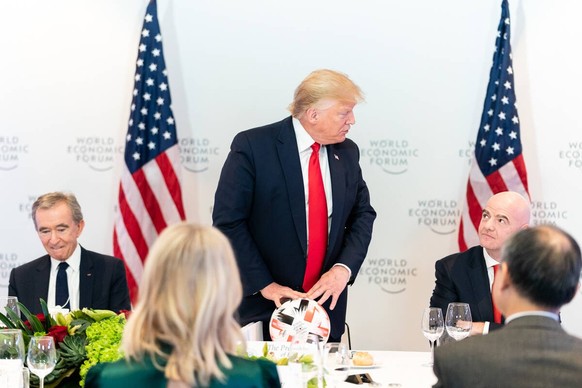 January 21, 2020, Davos, Switzerland : President DONALD TRUMP accepts a soccer ball from FIFA President GIANNI INFANTINO during the 50th Annual World Economic Forum meeting at the Davos Congress Centr ...