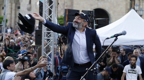 Armenian protest leader Nikol Pashinian throws baseball caps into the crowd during a rally in Yerevan on Monday, April 30, 2018. Armenia&#039;s parliament plans to choose a replacement on Tuesday for  ...