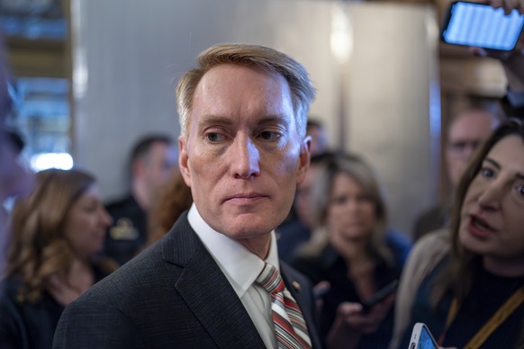 Sen. James Lankford, R-Okla., the lead GOP negotiator on a border-foreign aid package, speaks with reporters outside the chamber at the Capitol in Washington, Thursday, Jan. 25, 2024. Any bipartisan b ...