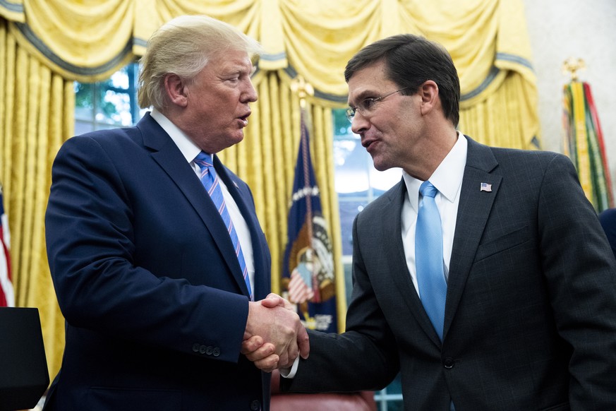 epaselect epa07736210 US President Donald J. Trump attends the ceremony of Mark Esper (R) being sworn-in as US Secretary of Defense, in the Oval Office of the White House in Washington, DC, USA, 23 Ju ...