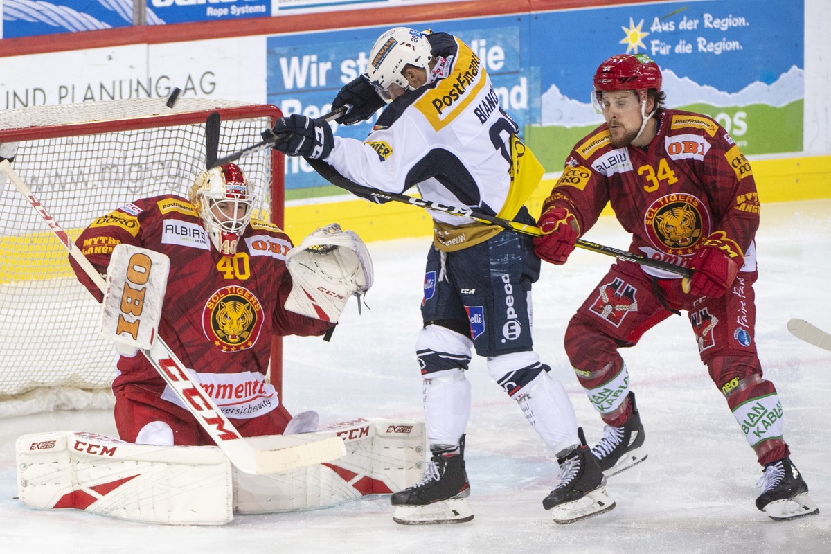 Tigers Goalie, Damiano Ciaccio, links, und Tigers, Claudio Cadonau, rechts, kaempft um den Puck, gegen Ambris, Elias Bianchi, Mitte, waehrend dem Meisterschaftsspiel der National League, zwischen den  ...