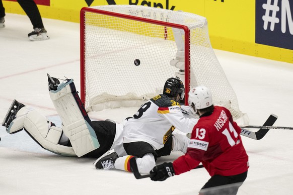 Switzerland's Nico Hischier, right, scores to 2-0 against Germany's Fabio Wagner, center, and Germany's goalkeeper Harald Grubauer during the Ice Hockey World Championship quarter final ...