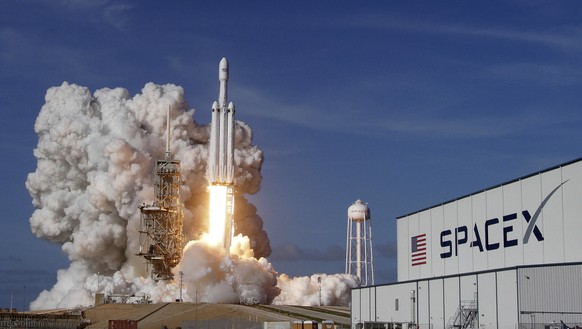 A Falcon 9 SpaceX heavy rocket lifts off from pad 39A at the Kennedy Space Center in Cape Canaveral, Fla., Tuesday, Feb. 6, 2018. The Falcon Heavy, has three first-stage boosters, strapped together wi ...