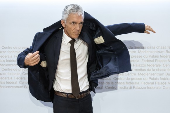 Swiss Federal Attorney Michael Lauber puts on his jacket at the end of a media conference at the Media Centre of the Federal Parliament in Bern, Switzerland, on Friday, 10 May 2019. Federal Attorney M ...