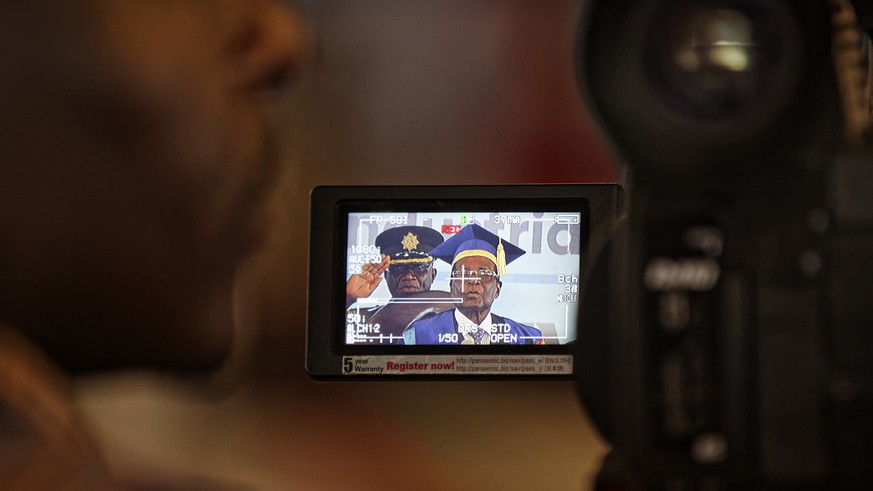 A television cameraman films Zimbabwe&#039;s President Robert Mugabe as he speaks at a student graduation ceremony at Zimbabwe Open University on the outskirts of Harare, Zimbabwe Friday, Nov. 17, 201 ...