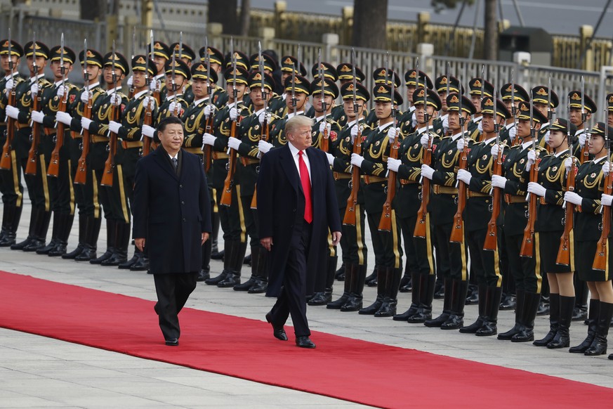 U.S. President Donald Trump, right, and Chinese President Xi Jinping attend a welcome ceremony at the Great Hall of the People in Beijing Thursday, Nov. 9, 2017. (AP Photo/Andy Wong)