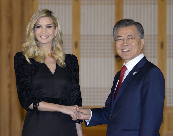 South Korean President Moon Jae-in shakes hands with Ivanka Trump during their dinner at the Presidential Blue House on Friday, Feb. 23, 2018, Seoul, South Korea. Ivanka Trump has received a red-carpe ...