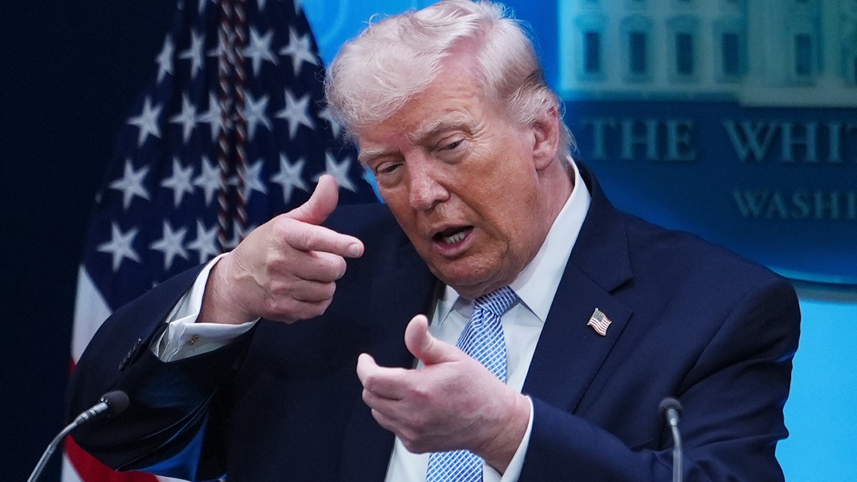 FILE - President Donald Trump pretends to aim a sniper gun while speaking with reporters in the James Brady Press Briefing Room at the White House, Monday, April 6, 2026, in Washington. (AP Photo/Juli ...