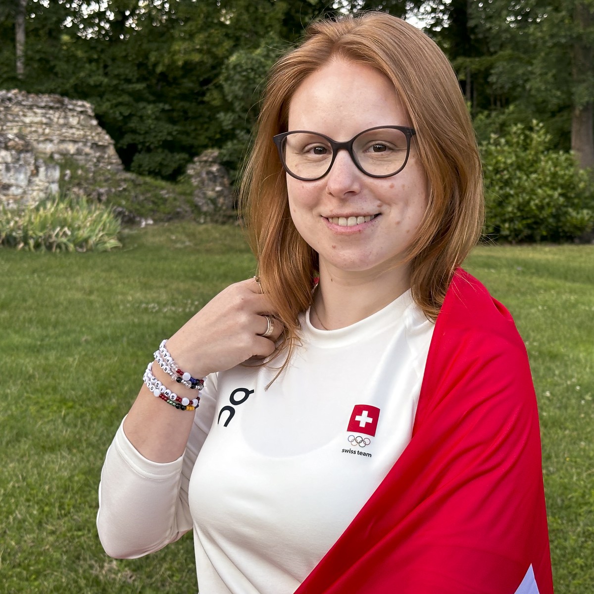 HANDOUT - This handout picture taken and released by Swiss Shooting shows the Swiss athlete in shooting sports Nina Christen with the Swiss flag, prior to the 2024 Paris Summer Olympics in Chateauroux ...