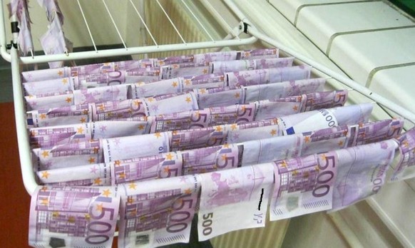 This undated photo, released by police in Vienna, shows banknotes hanging out to dry after they were found in Vienna's Danube River.  Austrian police dried out more than 100,000 euros ...
