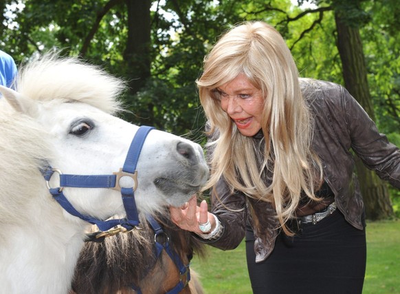 epa02780649 German actress Ingrid van Bergen pets a white pony at the zoo on her 80th birthday in Karlsruhe, Germany, 15 June 2011. The petting zoo burned down in 2010, destroying the elephant house a ...