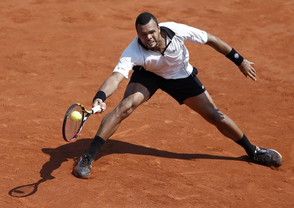 Jo-Wilfried Tsonga of France returns the ball to Stan Wawrinka of Switzerland during their men&#039;s semi-final match at the French Open tennis tournament at the Roland Garros stadium in Paris, Franc ...