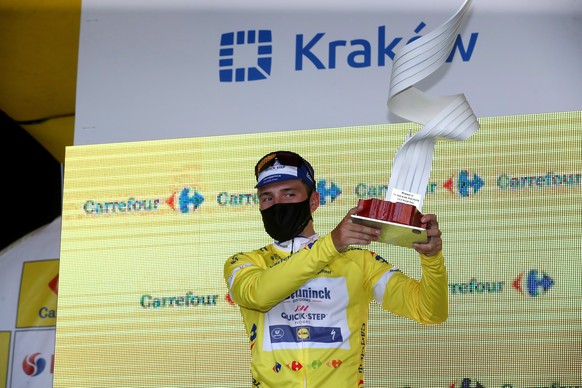 epa08594052 Belgian cyclist Remco Evenepoel of Deceuninck-Quick Step in a protective mask celebrates on the podium the overall win following the 5th and last stage of Tour de Pologne cycling race, ove ...