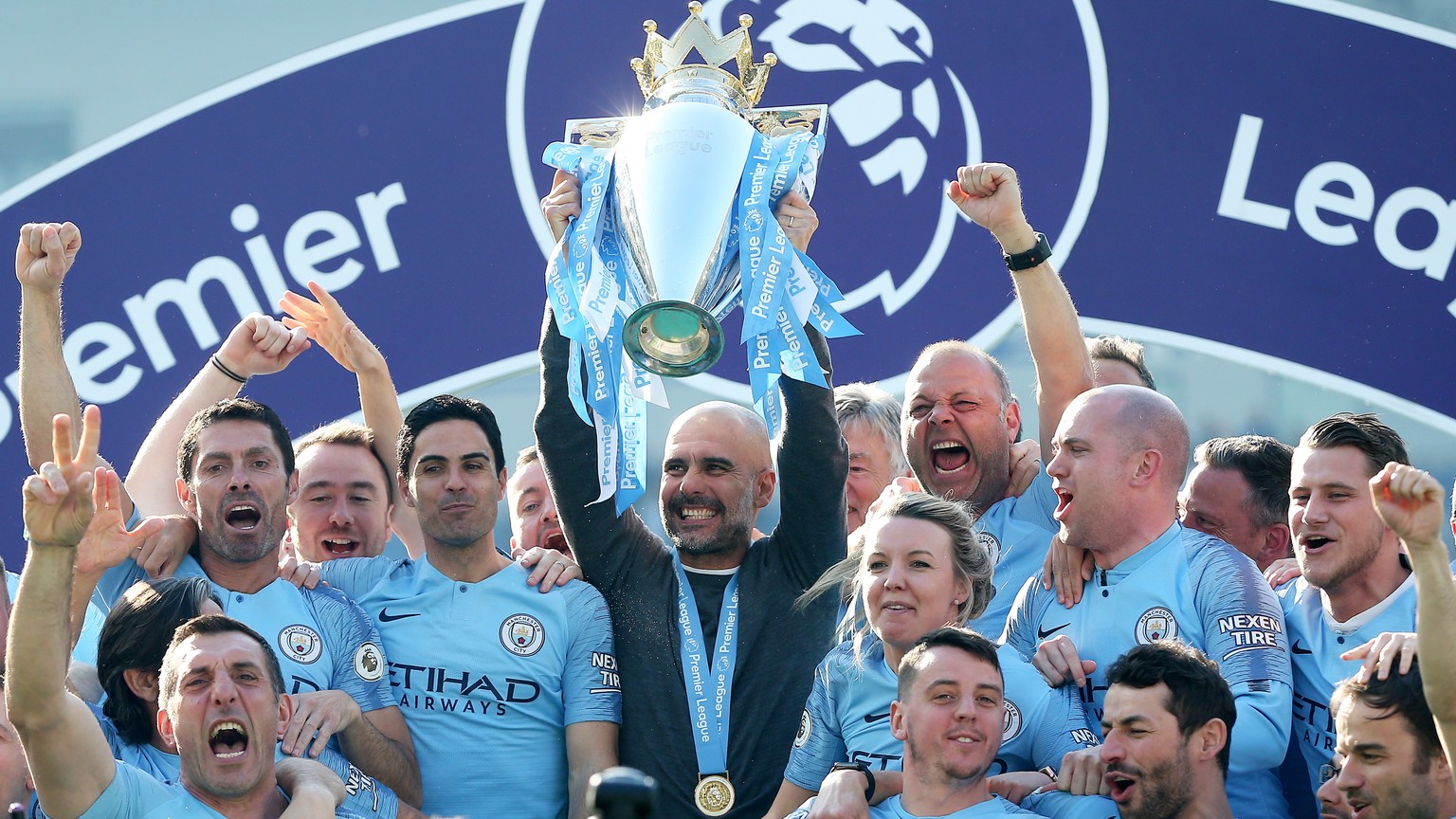 epa07565110 Manchester City manager Pep Guardiola lifts the trophy after the English Premier League match between Brighton and Hove Albion and Manchester City, Brighton, Britain, 12 May 2019. Manchest ...